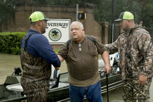 David Emswiler thanks the men rescuing him from his flooded house in Northwest Houston on Aug. 28, 2017. Later, four members of the Texas congressional delegation voted against a plan including hurricane aid (PHOTO: Jay Janner, AUSTIN AMERICAN-STATESMAN).