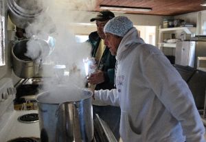 Art Helmrich, right, and Warren Hendrickson prepare a large pot of hot oatmeal for breakfast at the Holy Ground Homeless Shelter in Hudson, Fla. (Tampa Bay Times photo)