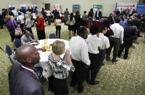 Job seekers line up in front of booths at a career fair in Arlington, Va., on Aug. 4, 2011. One day later, President Barack Obama got some good news on job creation.