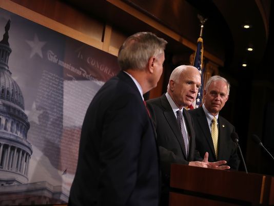 U.S. Sen. Ron Johnson (right) walked back comments he made about a fellow Republican, U.S. Sen. John McCain (center) and McCain's brain cancer. U.S. Sen. Lindsey Graham is also pictured. (Justin Sullivan/Getty Images)