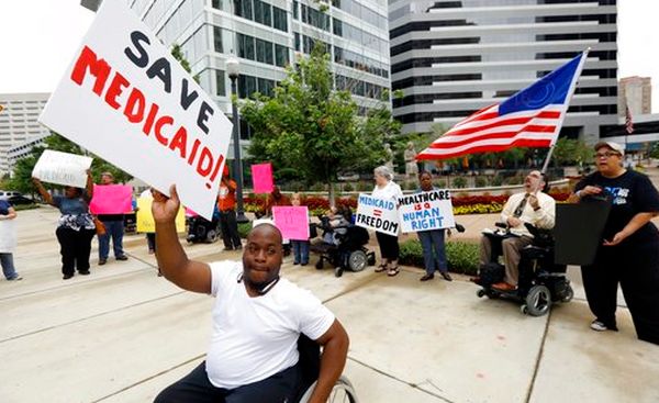 Mario Henderson leads chants of "save Medicaid" outside a Jackson, Miss., building that houses offices of Sen. Thad Cochran, R-Miss., on June 29, 2017.l (AP/Rogelio V. Solis)