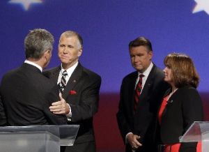 North Carolina GOP senatorial candidates Greg Brannon, left, and Thom Tillis shake hands as Mark Harris and Heather Grant, right, look on at a debate on April 28, 2014.