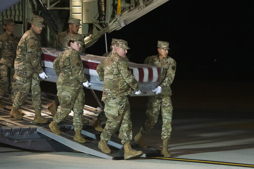 An Air Force carry team moves the transfer case containing the remains of Navy Seaman Apprentice Cameron Scott Walters, of Richmond Hill, Ga., Dec. 8, 2019, at Dover Air Force Base. A Saudi gunman killed three people at the Naval base in Pensacola. (AP)