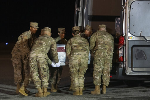An Air Force carry team moves a transfer case containing the remains of Navy Seaman Mohammed Sameh Haitham, of St. Petersburg, Fla., Dec. 8, 2019, at Dover Air Force Base, Del. A Saudi gunman killed three people including Haitham in a shooting. (AP)