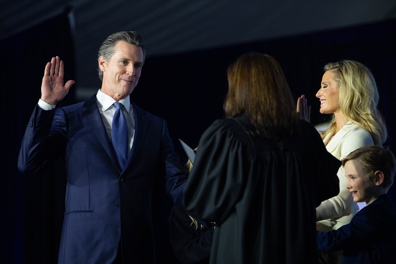 Gavin Newsom takes the oath of office as First Partner Jen Siebel Newsom and their four children stand beside him. Andrew Nixon / Capital Public Radio