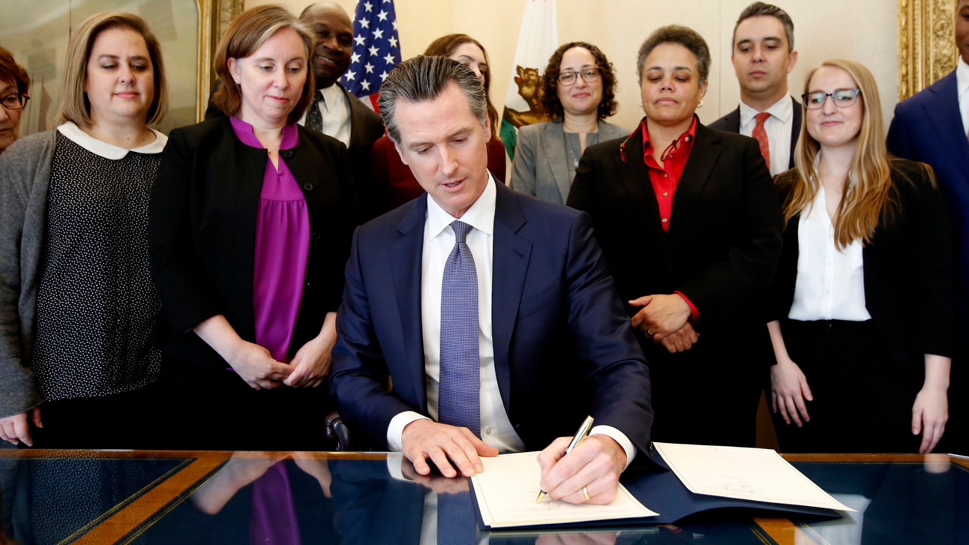 Gov. Gavin Newsom signs the executive order placing a moratorium on the death penalty at his Capitol office Wednesday, March 13, 2019, in Sacramento, Calif. Rich Pedroncelli / AP Photo