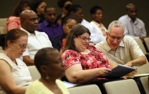Audience members take notes on health insurance marketplace exchanges in Atlanta July 13th, 2013. The event explained what the Affordable Care Act and the roll out of the online health insurance exchanges mean for consumers. (AJC Photo/Phil Skinner)
