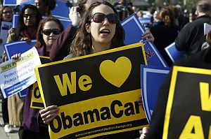 Supporters of health care reform stand in front of the Supreme Court in Washington on March 28, 2012. (AP Photo)