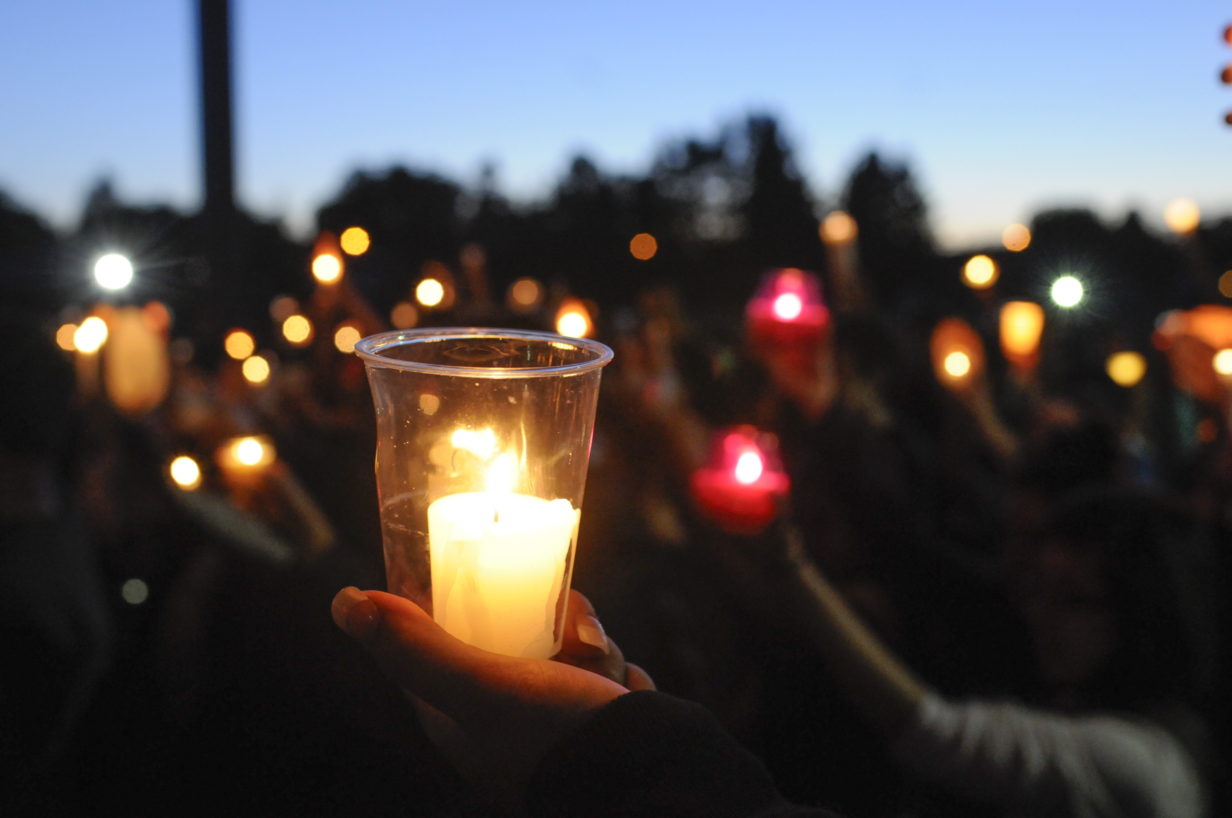 Students, faculty and parents gather for a candlelight vigil to remember a Reynolds High School student shot and killed at the school Tuesday morning. The shooter, also a Reynolds student, took his own life.