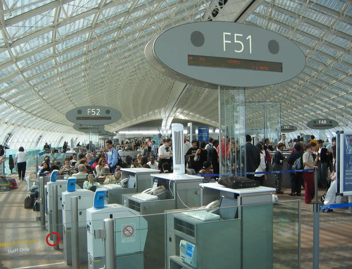 Passengers at Charles de Gaulle Airport in Paris. A House lawmaker raises a concern about Europeans not needing a visa to fly to America. (Darren Kulp)