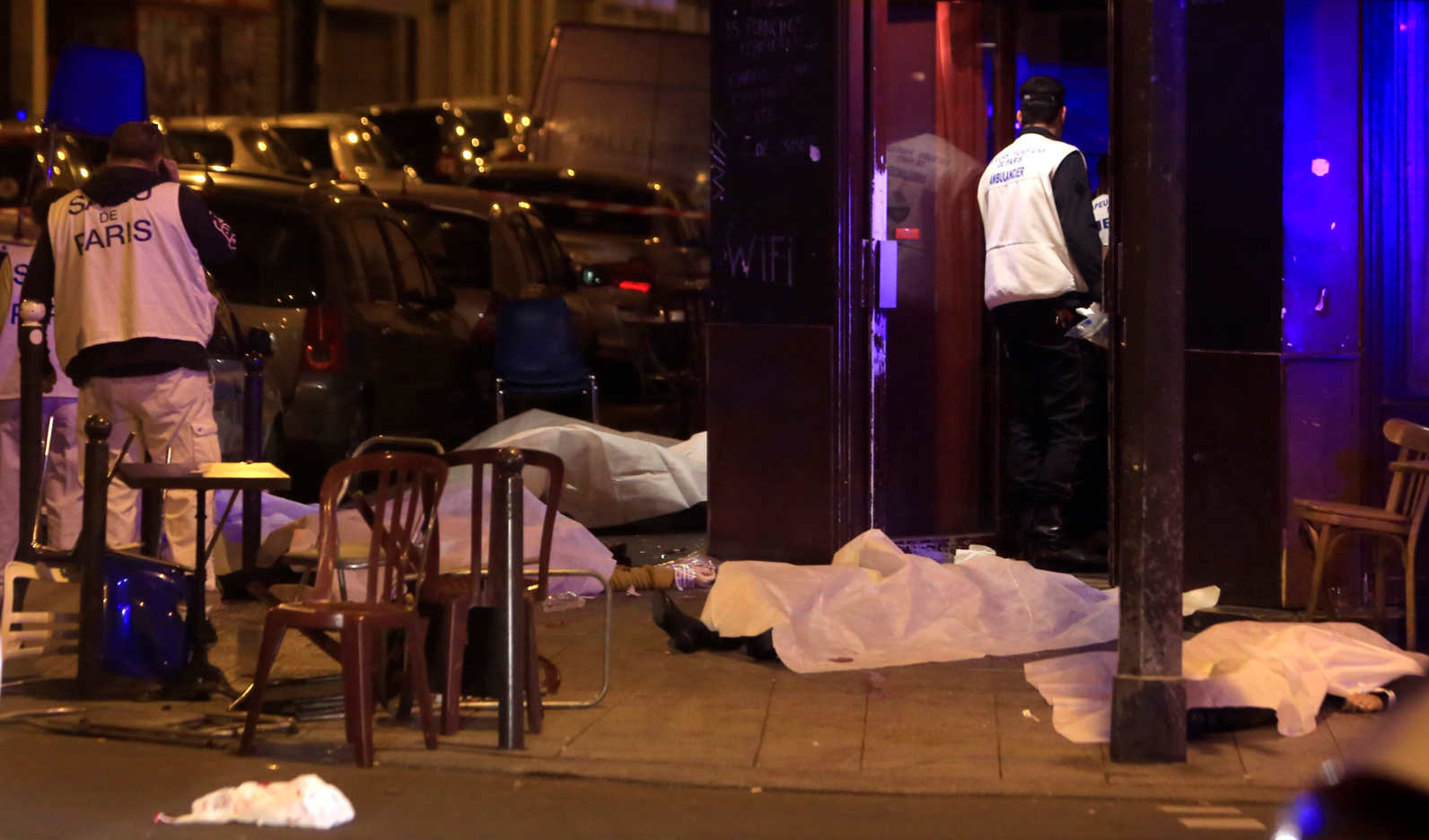 Victims's bodies lie on the sidewalk outside a Paris restaurant following a wave of attacks Friday. (AP)