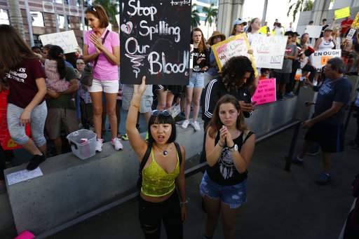 A demonstrator holds a sign saying "Stop Spilling Our Blood" during a protest against guns in Fort Lauderdale, Fla., three days after the school shooting in Parkland, Fla. (Associated Press)