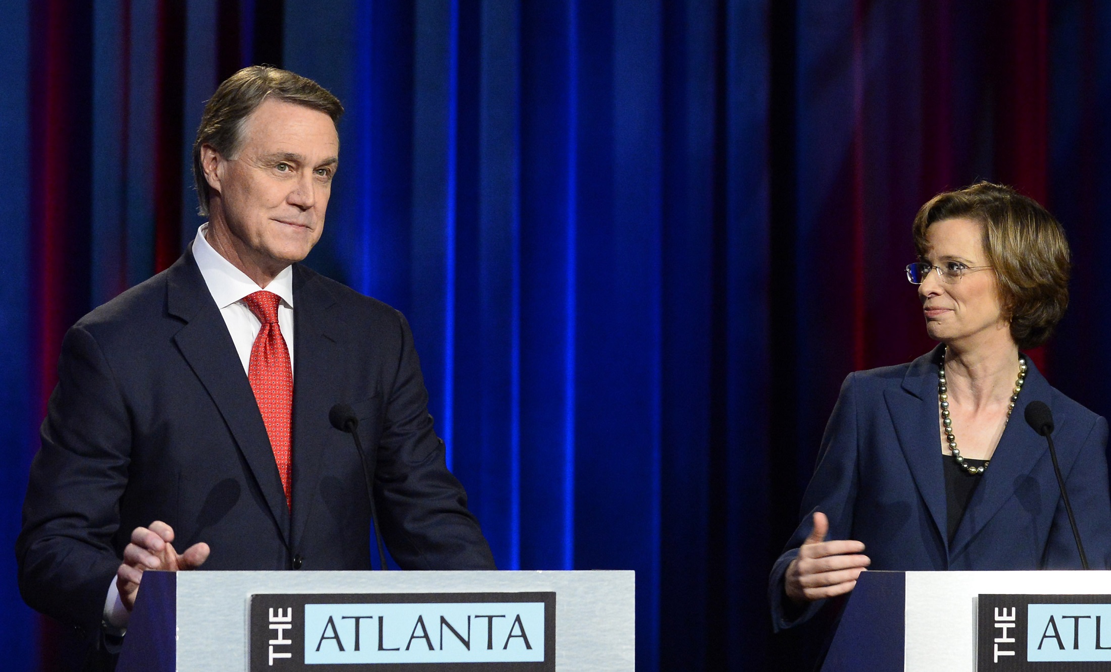 U.S. Senate hopefuls Republican David Perdue and Democrat Michelle Nunn focused mainly on two key talking points during their Atlanta Press Club debate on Oct. 26. David Tulis/ for the AJC