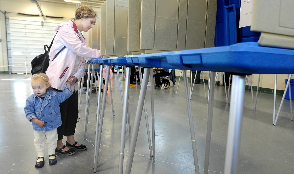 Wisconsin voters soon will be required to show photo IDs at the polls, under legislation signed by Gov. Scott Walker. This Journal Sentinel file photo shows a voter from Sussex in 2008.