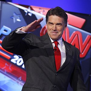 Republican presidential candidates Texas Gov. Rick Perry salutes the crowd before a Republican presidential debate Oct. 18 in Las Vegas.