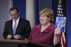 Council of Economic Advisers Chair Christina Romer holds up a copy of the 'Economic Report of the President' for 2010.