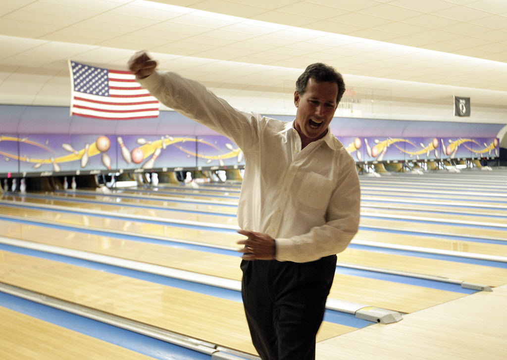 In this Associated Press photo, GOP presidential hopeful Rick Santorum celebrates bowling a strike while campaigning in Wisconsin.