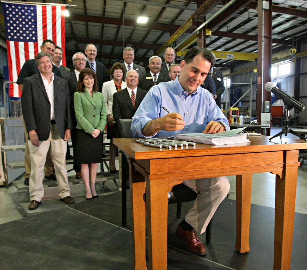 Wisconsin Gov. Scott Walker signs the 2011-13 state budget