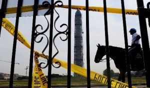 A mounted police officer passes in front of the Washington Monument and the World War II memorial on the Mall in Washington during a federal shutdown on Oct. 3, 2013.