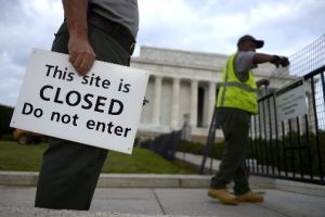 U.S. Park Service personnel erect barriers and hang signs as they close the Lincoln Memorial in Washington, on Oct. 1, 2013, the start of a federal government shutdown.