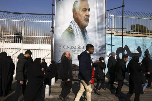 Mourners walk back from a funeral ceremony for Iranian Gen. Qassem Soleimani in front of the former U.S. Embassy, in Tehran. (AP Photo/Vahid Salemi)