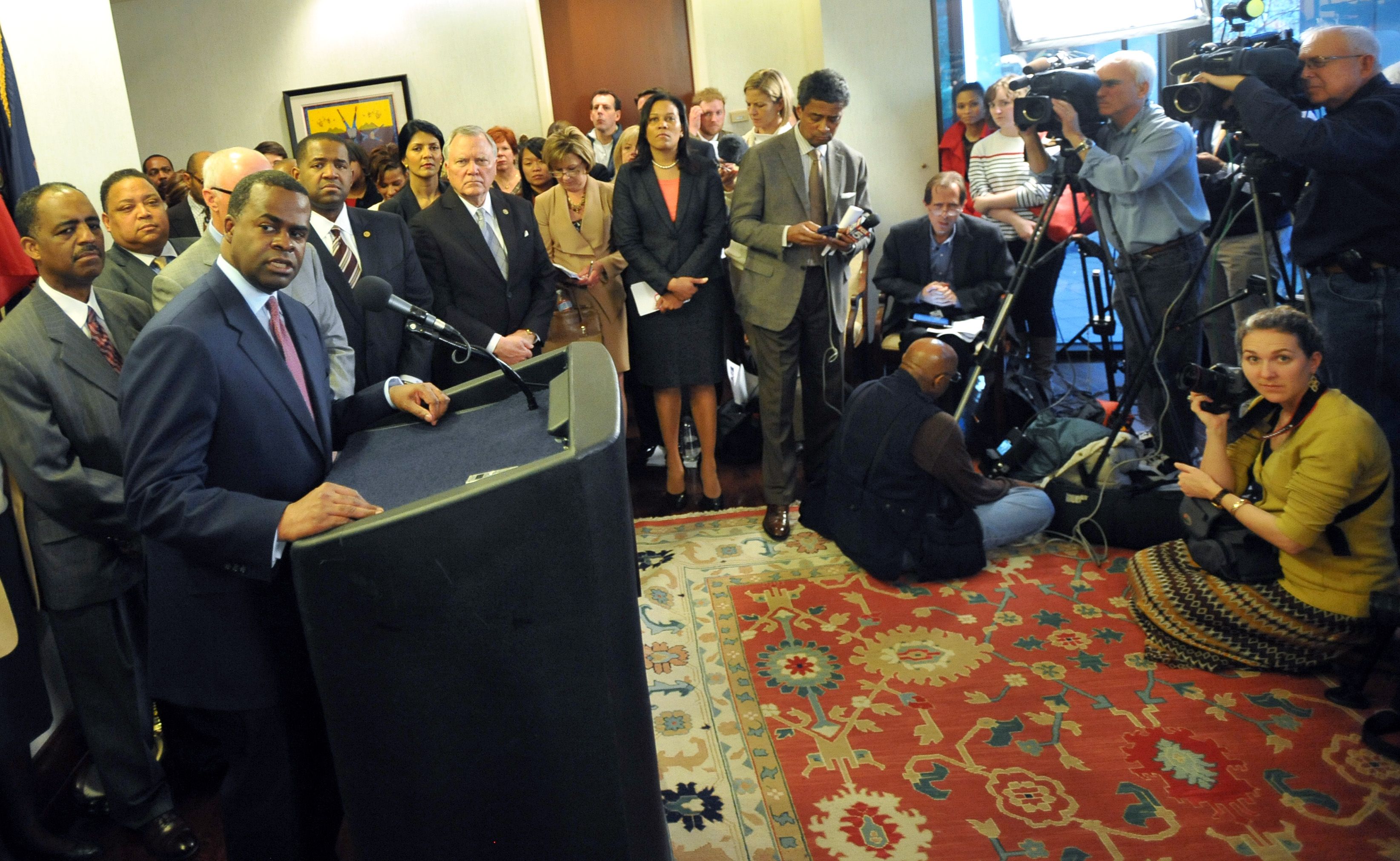 Atlanta Mayor Kasim Reed, standing at the microphone, takes a question from a reporter during a March 7, 2013 press conference to announce a deal with the Atlanta Falcons on a $1 billion stadium.