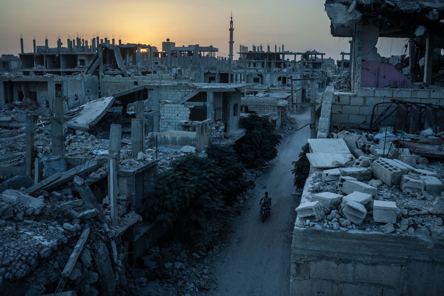 A motorcyclist travels through a heavily damaged neighborhood in Kobane, Syria, which was targeted by a series of U.S.-led coalition airstrikes aimed at the Islamic State. (The Washington Post)