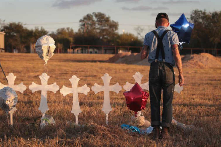 Derrick Bernaden of San Antonio, Texas visits a memorial where 26 crosses stand in a field on the edge of town to honor the 26 victims killed at the First Baptist Church of Sutherland Springs. (Getty Images)