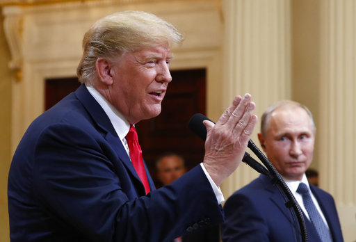 President Donald Trump speaks as Russian President Vladimir Putin looks on during a press conference after their meeting at the Presidential Palace in Helsinki, Finland. (AP Photo/Pablo Martinez Monsivais)
