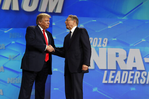 President Donald Trump shakes hands with NRA executive vice president and CEO Wayne LaPierre, has he arrives to speak to the annual meeting of the National Rifle Association, Friday, April 26, 2019, in Indianapolis. (AP)