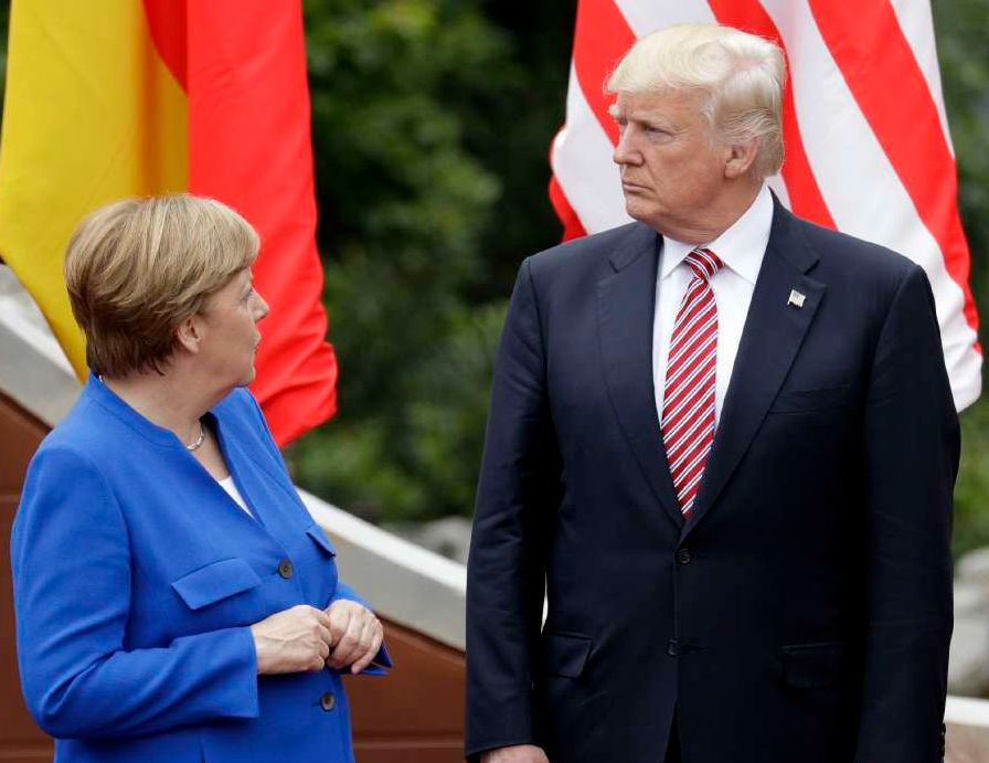 German Chancellor Angela Merkel, left, speaks with President Donald Trump during a group photo at the G7 Summit in Taormina, Italy, on May 26, 2017. (AP/Andrew Medichini)