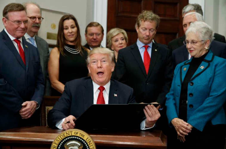 President Donald Trump signs executive order to expand association health plans. (AP)