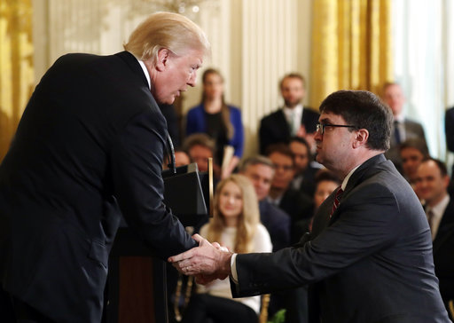 President Donald Trump shakes hands with Acting Veterans Affairs Secretary Robert Wilkie, during an event on prison reform in the East Room of the White House May 18, 2018, in Washington. (AP)