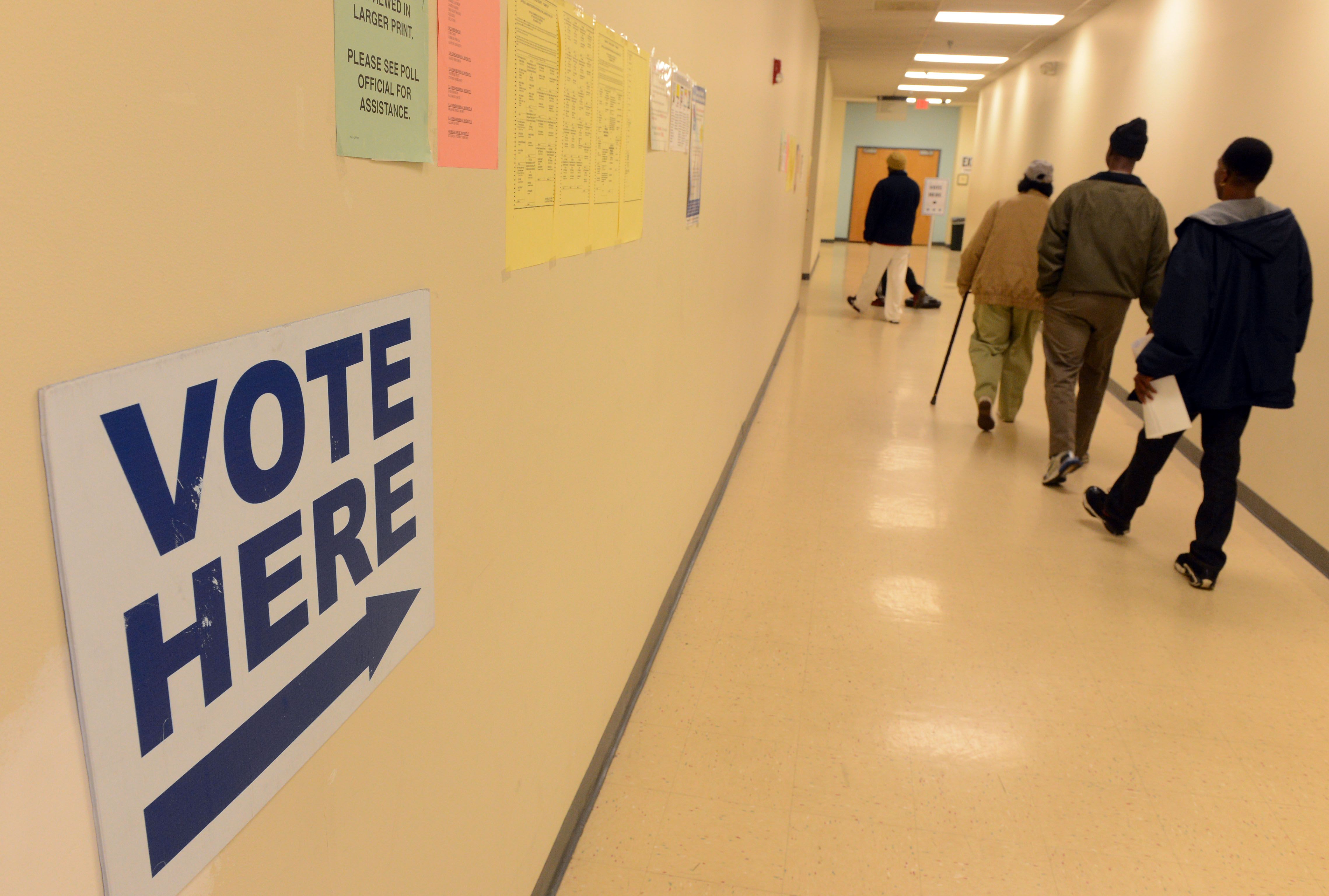 Signs direct voters to the polls at the DeKalb County Voter Registration and Elections office near Decatur, Ga., (Kent Johnson/AJC)