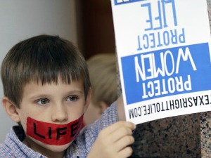 A boy holds a sign at the Texas Capitol on July 8, 2013, the same day speakers at an evening rally said Texas has 80,000 abortions a year (Associated Press, Eric Gay).