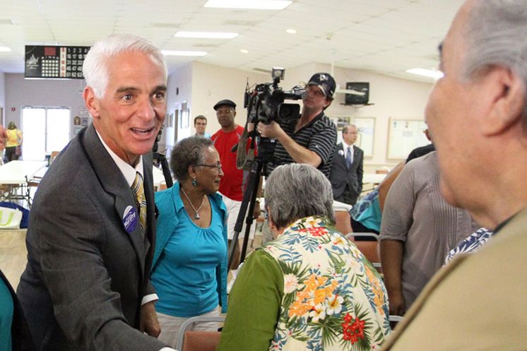 Charlie Crist greets a voter on the campaign trail. (Tampa Bay Times photo)