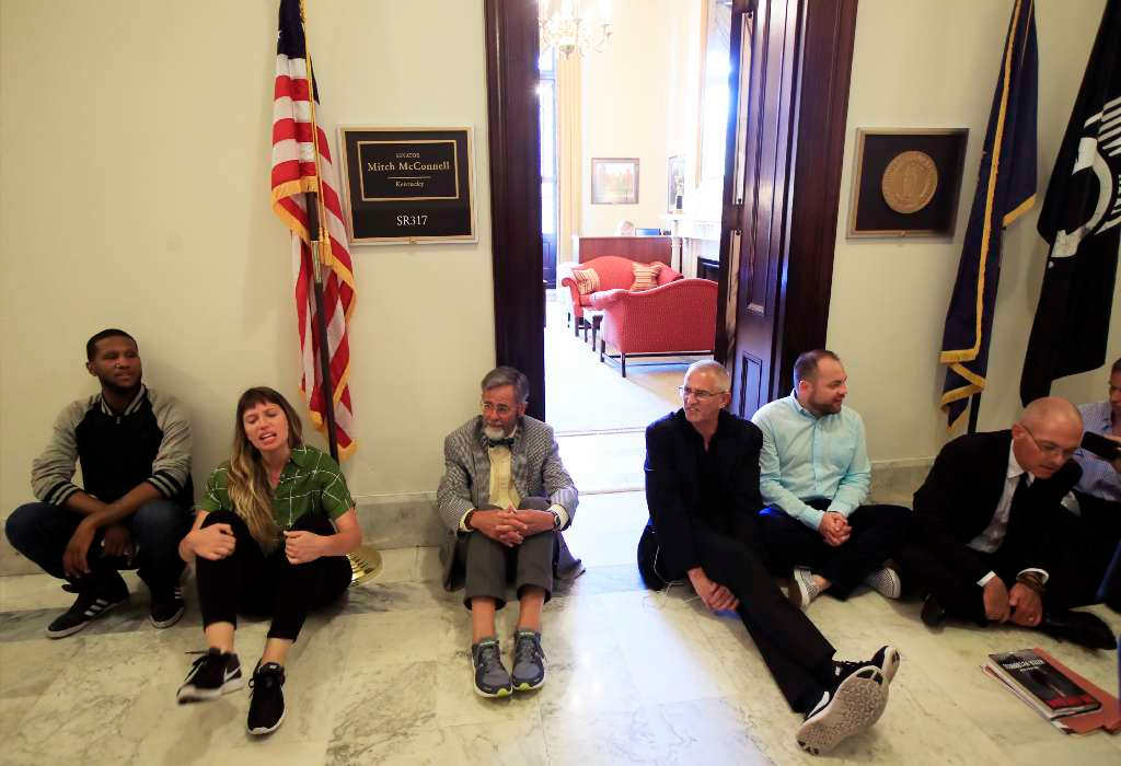 Protesters against the Republic health care proposals sit outside the office of Senate Majority Leader Mitch McConnell. (AP)