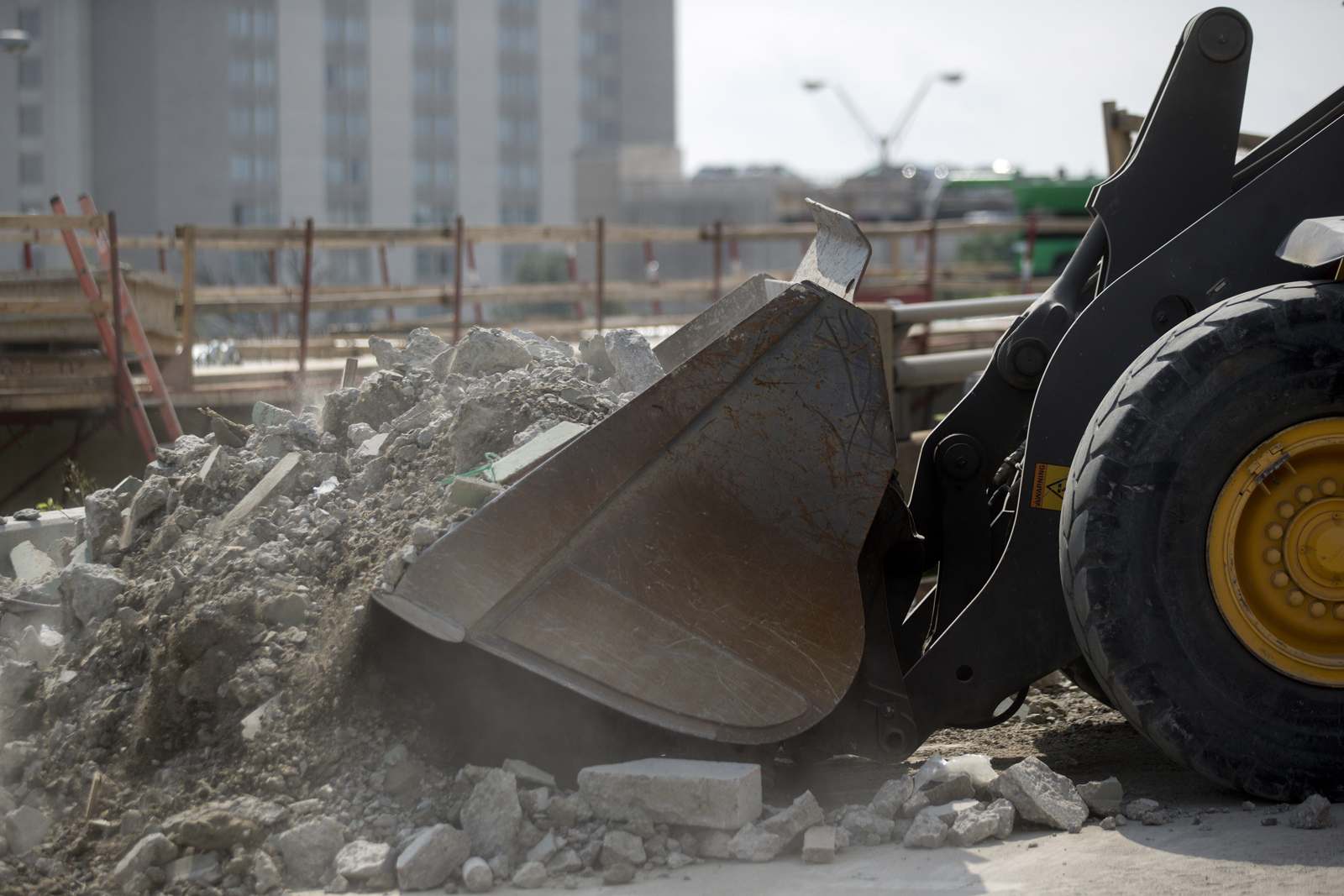 A wheel loader scoops debris from the Seminary Road overpass being demolished above Interstate 395 during a Virginia Department of Transportation project in Alexandria, Va., in 2015. (Bloomberg/Andrew Harrer)