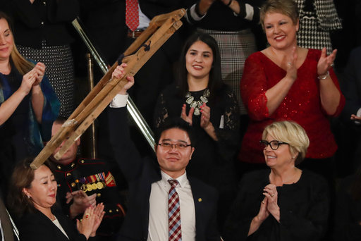 Ji Seong-ho holds up his crutches after his introduction by President Trump during the State of the Union address to a joint session of Congress on Capitol Hill in Washington, Jan. 30, 2018. (AP)