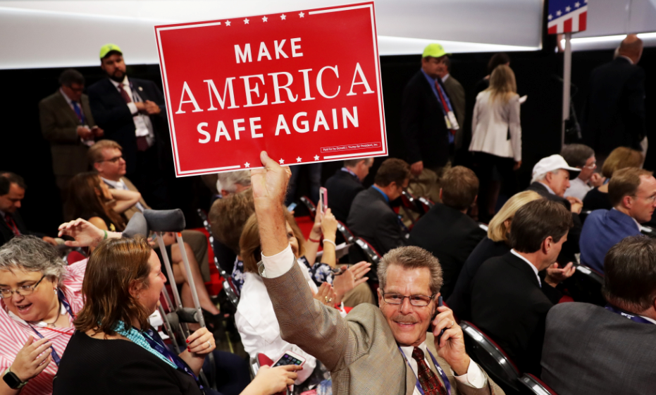 A delegate holds a sign that reads "Make America Safe Again" prior to the start of the evening session on the first day of the Republican National Convention on July 18, 2016 at the Quicken Loans Arena in Cleveland, Ohio. (Getty)