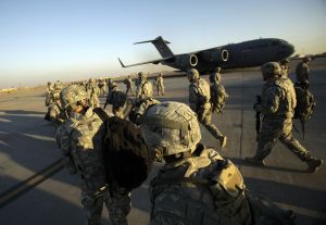 Troops walk toward a C-17 aircraft at Sather Air Base in Iraq. (2010 AP Photo)