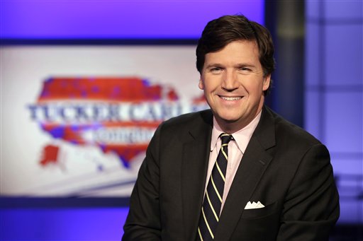 Fox News talk show host Tucker Carlson poses for photos in a Fox News Channel studio in New York on March 2, 2017. (AP/Drew)