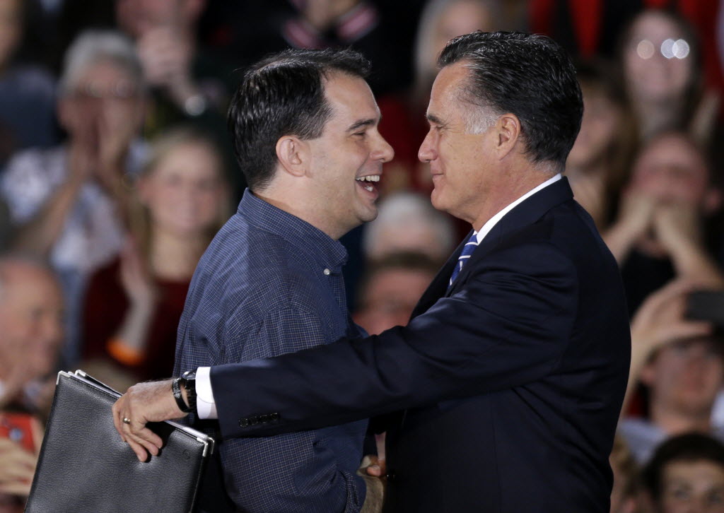 Republican presidential candidate Mitt Romney embraces Gov. Scott Walker at a 2012 campaign event in West Allis. (AP Photo)