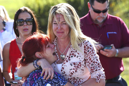 Parents wait for news after a reports of a shooting at Marjory Stoneman Douglas High School in Parkland, Fla., on Wednesday, Feb. 14, 2018. (AP)